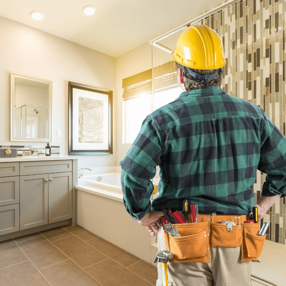 Homeowner reviewing kitchen remodel plans with contractor inside King County home before construction begins