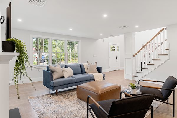 Contractor discussing home addition plans with homeowner in a bright Redmond living room