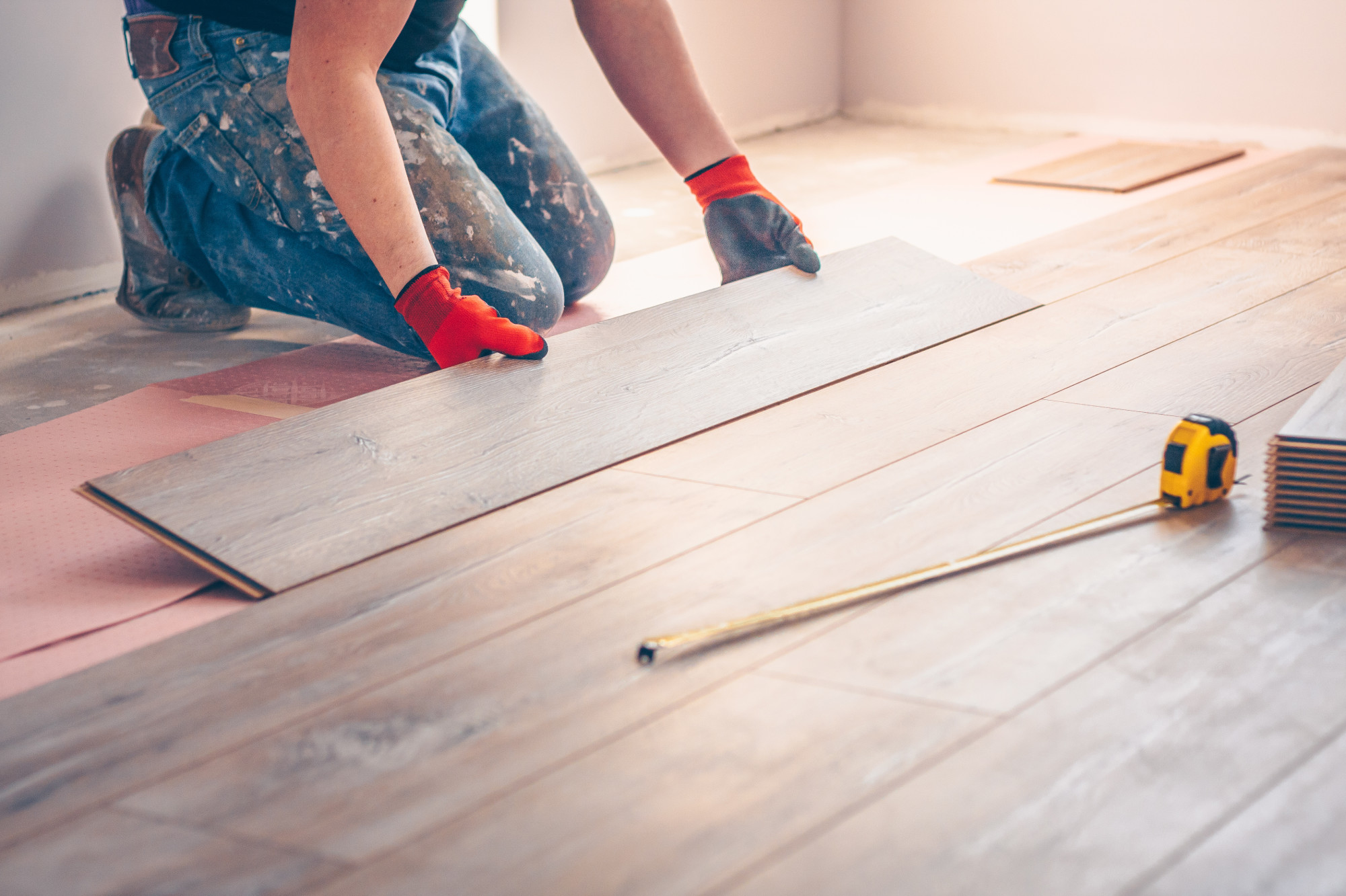 Trusted contractor using moisture meter on subfloor before installing engineered wood in an Issaquah townhouse