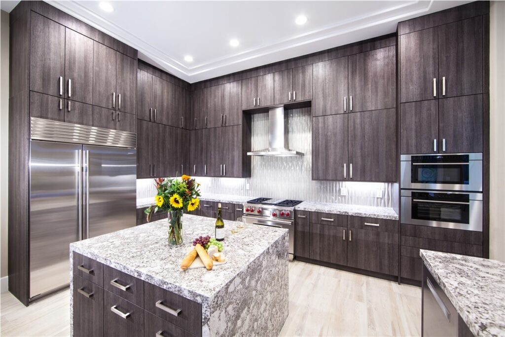 Designer reviewing luxury countertop and cabinet finishes inside a spacious Bothell, WA kitchen during remodel