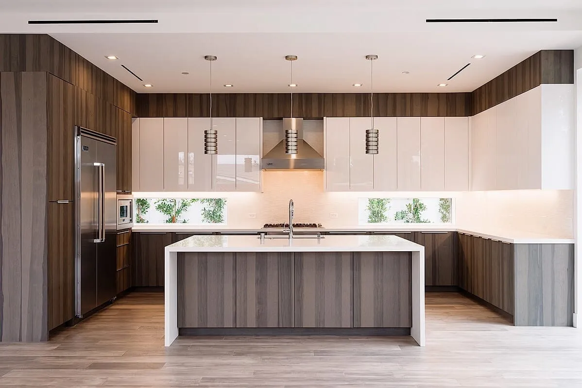 Installer aligning sleek kitchen cabinets and fixtures in a modern Redmond, WA home during renovation