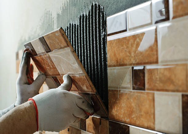 Tile Contractor reviewing shower wall alignment during a Bellevue, WA bathroom renovation