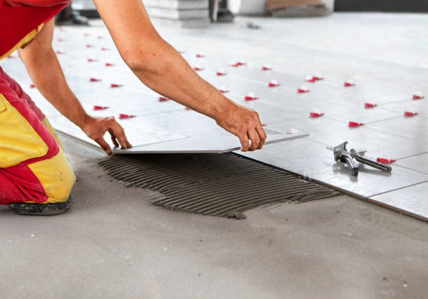 Tile Contractor in Sammamish, WA aligning porcelain floor tile in a kitchen remodel