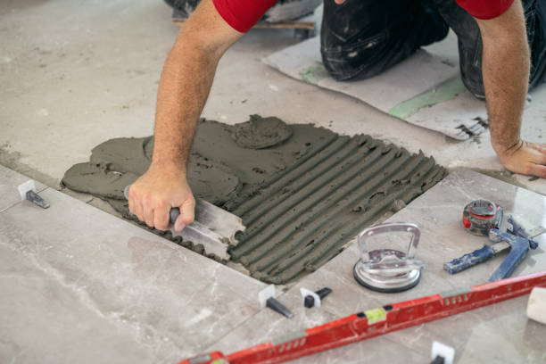 Tile Contractor checking floor alignment in an Issaquah, WA kitchen remodel