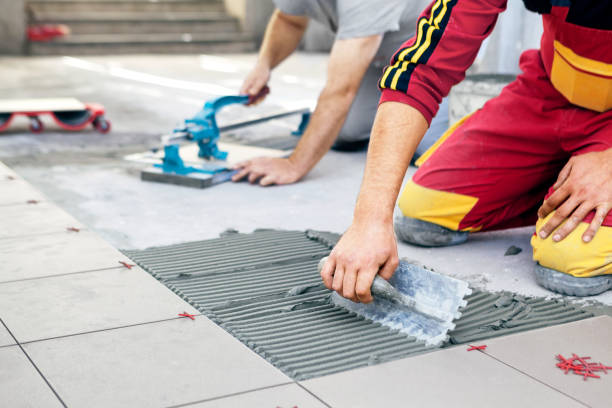 Tile Contractor in Bothell, WA aligning large-format floor tile in a bathroom remodel