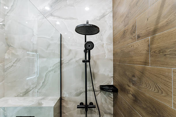 Shower Remodel in Issaquah, WA in progress as a contractor installs frameless glass beside new tile walls