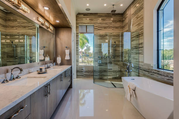 Designer reviewing a Shower Remodel plan inside an Issaquah, WA bathroom before tile layout begins