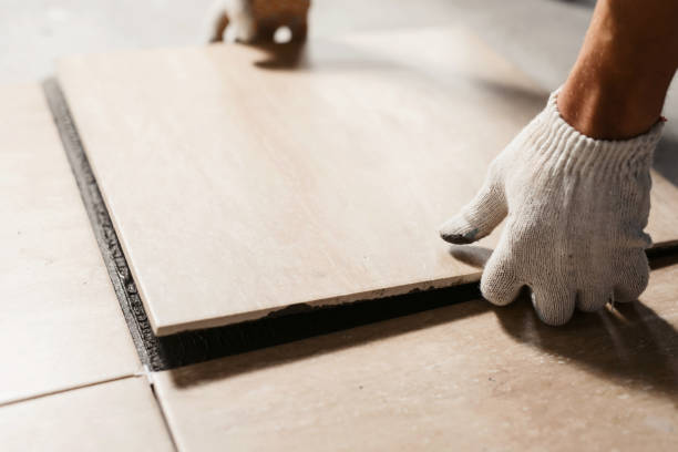 Technician measuring Flooring Installation layout inside a Bothell, WA home before securing transition pieces