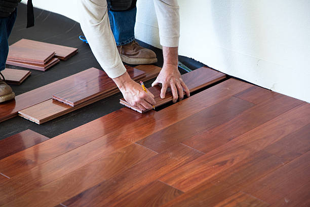 Flooring Installation in Issaquah, WA in progress as a crew fits planks along a bright hallway